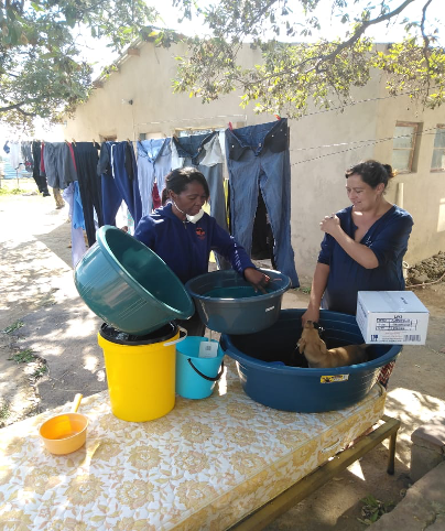Nurse Grace with donations of clothes, bedding May 2020