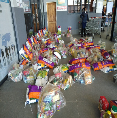 Nurse Grace with food parcels purchased in suppermarket